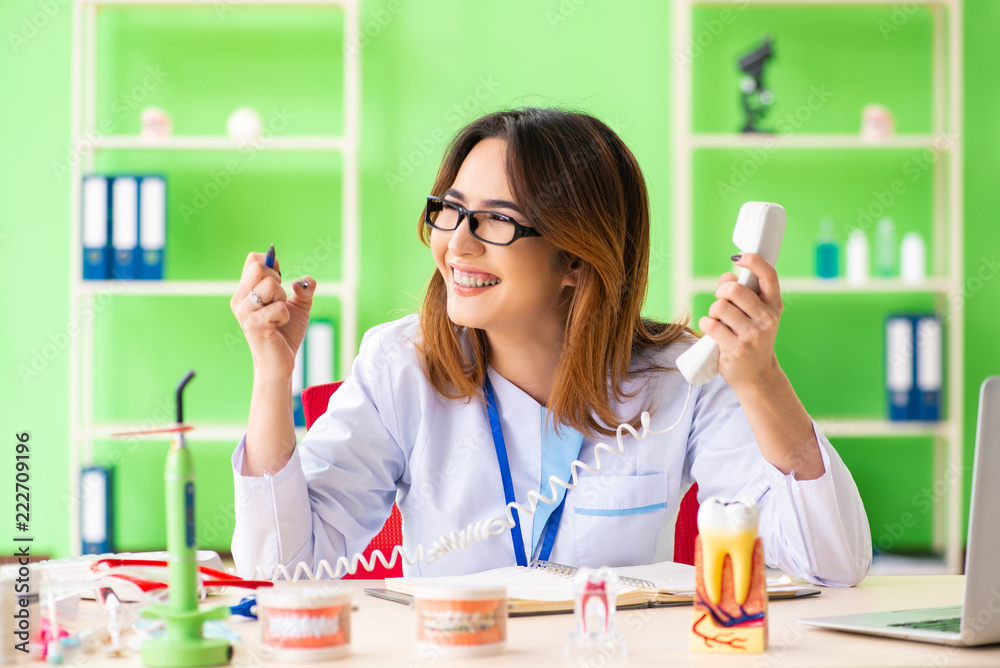 Woman dentist working on teeth implant Woman dentist working on teeth implant