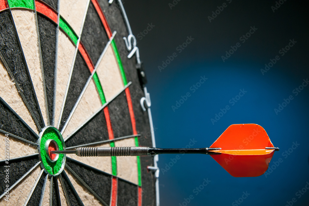 Close-up view of a red dart on the bullseye of a dartboard