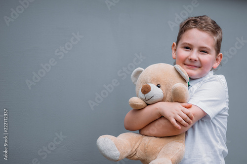Safety concept. The boy is holding teddy bear