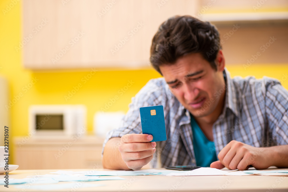 Young man husband in budget planning concept Young man husband in budget planning concept