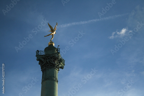 July Column (Colonne de Juillet) with its iconic sculpture of Genie de la Liberte, Auguste Dumont, on Bastille Square during a sunny afternoon. Dedicated to French revolution, it's a symbol of Paris photo