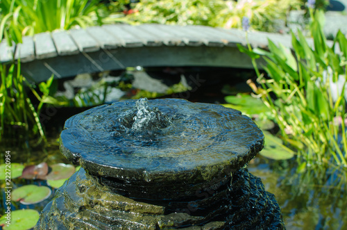 Bubbling decorative fountain in pond