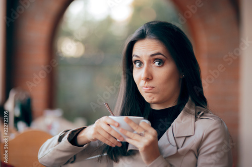 Funny Squeamish Girl with Hot Chocolate Drink photo