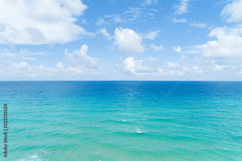 People enjoy swimming in tropical sea and wave crashing on sandy shore at karon beach in phuket thailand,aerial view drone shot.