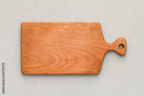 Cherry wood cutting board on linen, handmade wood cutting board