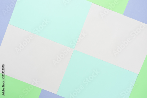 Table top view aerial image of colorful pastel paper background concept.Abstract flat lay pink blue purple and green wallpaper.