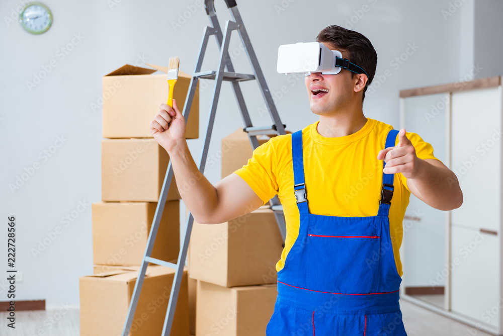 Painter contractor working with virtual reality goggles Painter contractor working with virtual reality goggles