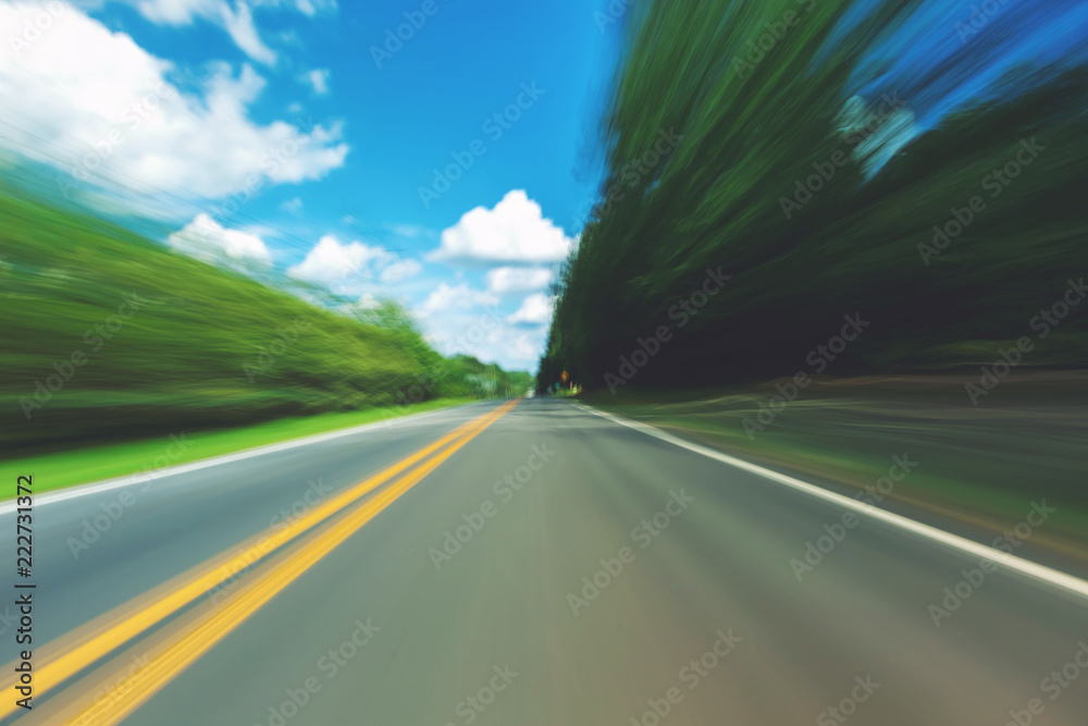 Motion blurred view of the street on a sunny day Motion blurred view of the street on a sunny day