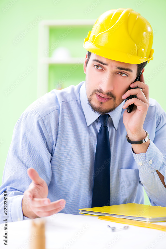 Young male architect working at the project Young male architect working at the project