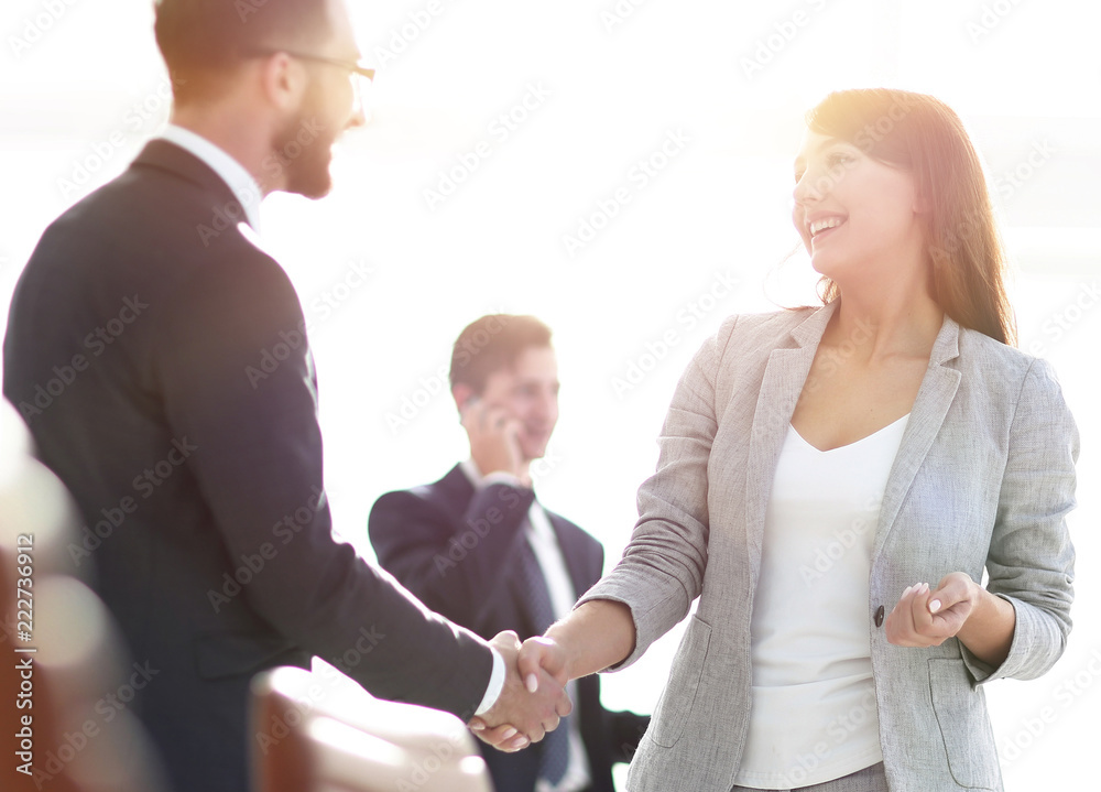 handshake between colleagues in the workplace handshake between colleagues in the workplace