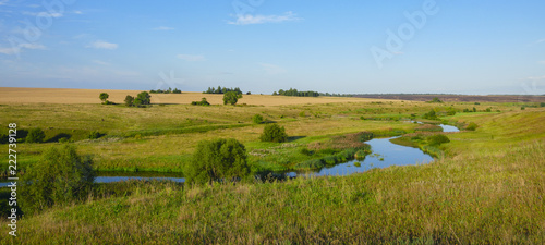 Sunny summer landscape with fields,river and beautiful woods.Beautiful panoramic view.