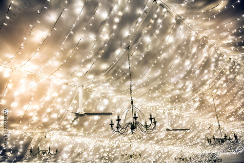 Twinkling party lights decorating a marquis roof photo