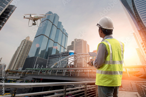 Drone inspection. Operator inspecting construction building