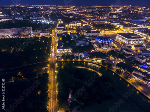 Panoramic aerial view of illuminated street and city buildings at night. Minsk, Belarus