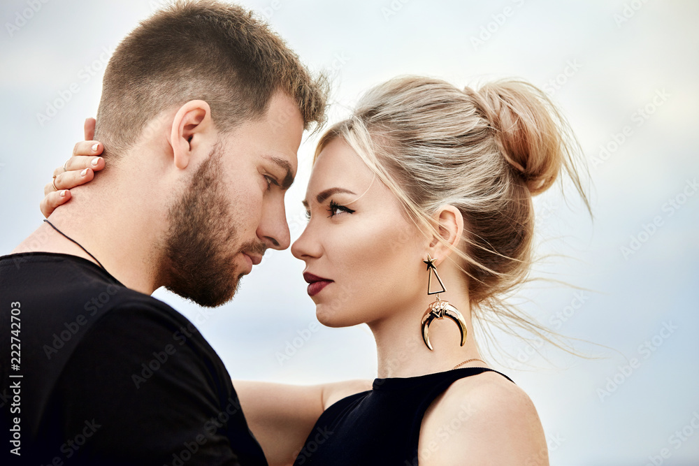 Love and emotions loving couple resting in Turkey. In love Eastern couple in the mountains of Cappadocia hugs and kisses. Close-up portrait of a man and woman. Beautiful Crescent earrings on girl ears Love and emotions loving couple resting in Turkey. In love Eastern couple in the mountains of Cappadocia hugs and kisses. Close-up portrait of a man and woman. Beautiful Crescent earrings on girl ears