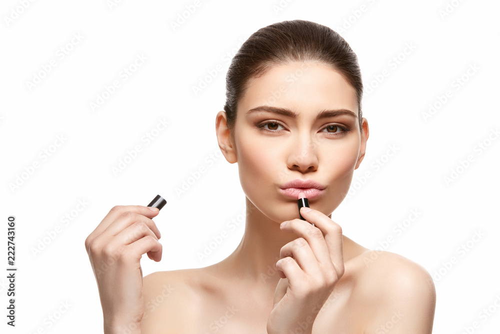 girl applying pink lipstick isolated on white girl applying pink lipstick isolated on white