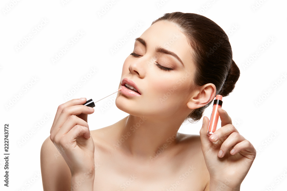 girl applying pink lipstick isolated on white girl applying pink lipstick isolated on white