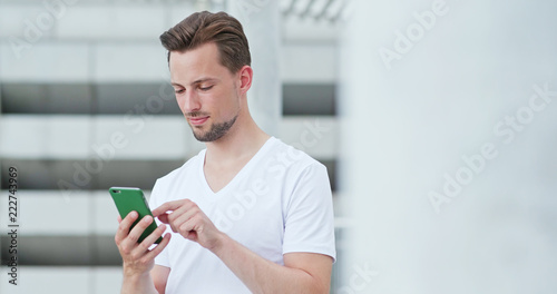 Photography Caucasian man work on cellphone in city