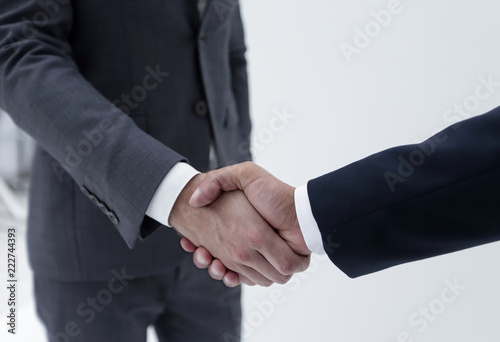 Businessman by handshake invites to cooperation.