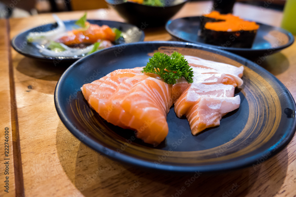 Fresh raw salmon on black plate Fresh raw salmon on black plate