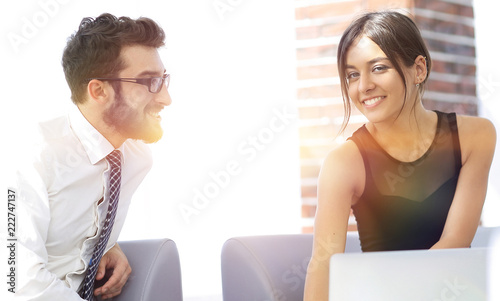 Man and woman are at the table in office.