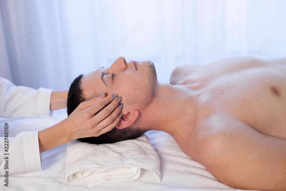 masseuse makes a therapeutic massage of the head and neck man Spa masseuse makes a therapeutic massage of the head and neck man Spa