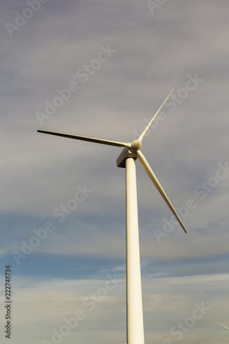 wind generator on blue sky background. electricity production. place for text