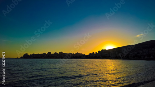 Sunset Panoramic view to Saranda city and bay of Ionian sea, Albania © homocosmicos