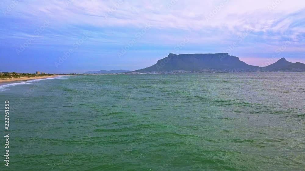 fly over beach revealing table mountain and sunset