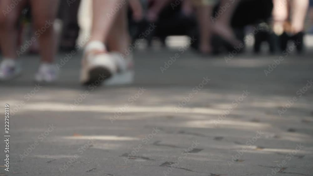 Close-up of foot walking people on the sidewalk. People hurrying about their business Close-up of foot walking people on the sidewalk. People hurrying about their business