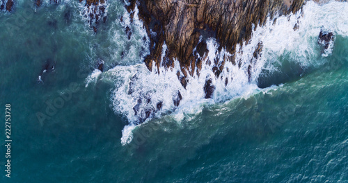 Photography Aerial view of waves crashing on rocks,Seascape with birds eye view shot over oc