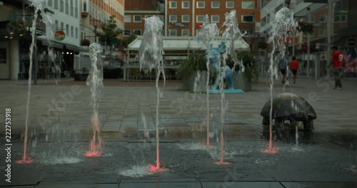 Water shooting from lit up holes in the ground in central Västerås
