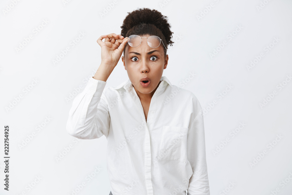 You did what. Portrait of shook intense african-american woman seeing unbelievable and terrible mess, taking off glasses, folding lips and frowning, cannot understand what happened, being shocked You did what. Portrait of shook intense african-american woman seeing unbelievable and terrible mess, taking off glasses, folding lips and frowning, cannot understand what happened, being shocked
