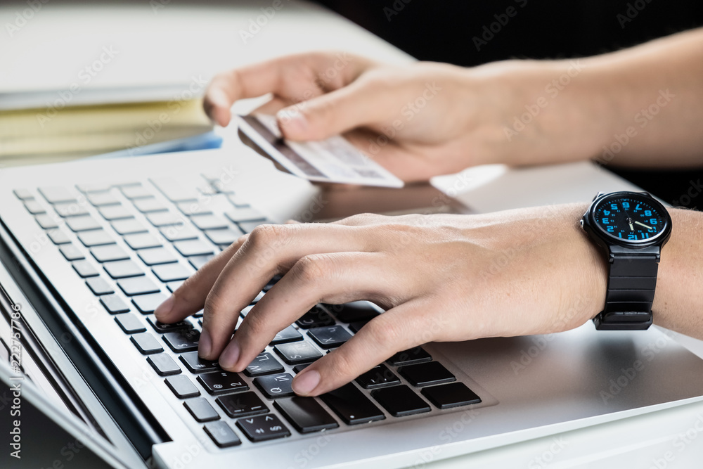 Using credit card for online payment. Person filling bank account information while purchasing something in internet Using credit card for online payment. Person filling bank account information while purchasing something in internet