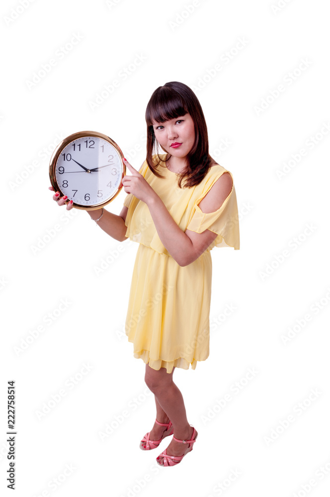 Brunette girl in yellow dress holding a large watch Brunette girl in yellow dress holding a large watch
