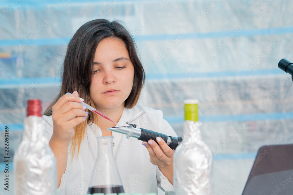 Young female technician in the quality control laboratory use Refractometer Young female technician in the quality control laboratory use Refractometer