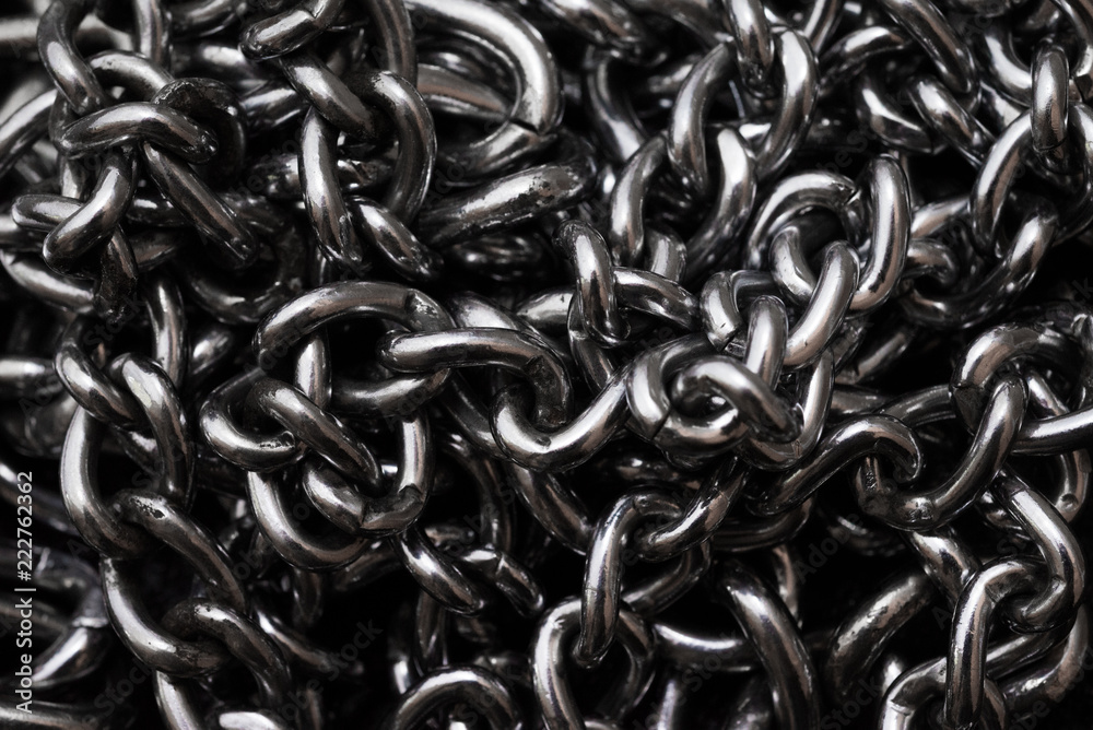 Metal silver chains on luxury black leather texture. Metal silver chains on luxury black leather texture.