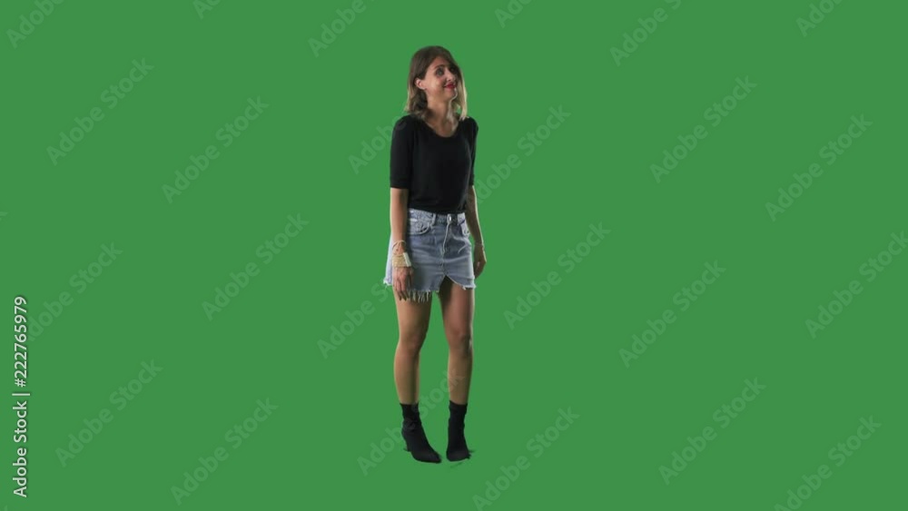 Pretty stylish girl showing spinning finger on temple crazy gesture isolated on green screen background Pretty stylish girl showing spinning finger on temple crazy gesture isolated on green screen background