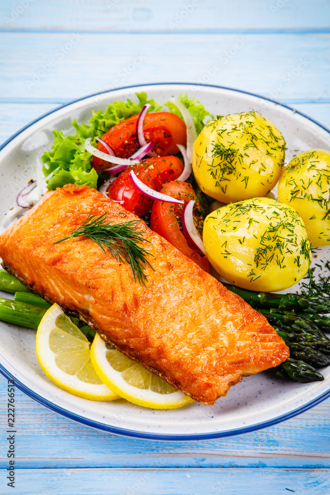 Grilled salmon with boiled potatoes, asparagus and vegetable salad Grilled salmon with boiled potatoes, asparagus and vegetable salad