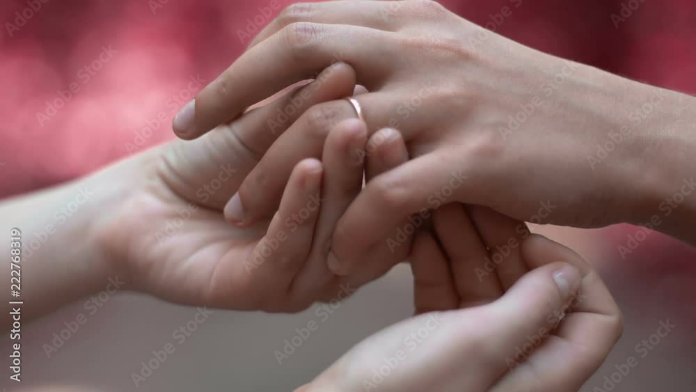 Lesbians wearing rings on ceremony, wedding of same-sex love partners, close-up Lesbians wearing rings on ceremony, wedding of same-sex love partners, close-up