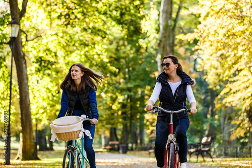 Healthy lifestyle - people riding bicycles in city park