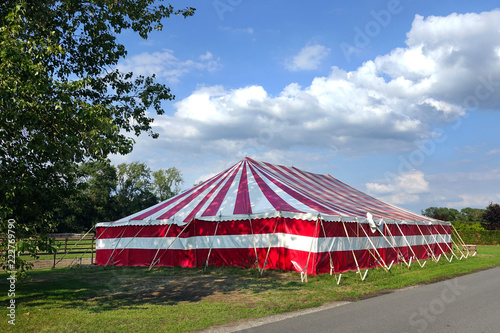 Large party Marquee, red and white stripped event tent set in the countryside.