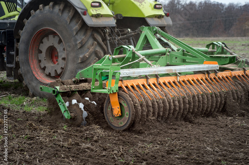 The disk harrow. Tractor blades for plowing land in the agriculture industry. Agricultural machinery for processing of the soil in the field.