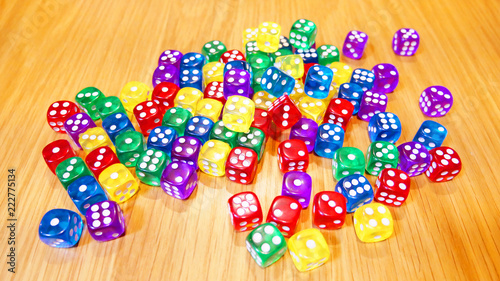 Colorful of dices on the wood table.