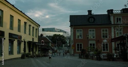 Timelapse of people walking on a small street crossing the canal in central Västerås.
