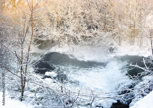 Frosty morning with a mist over a river with trees in the snow © antonkuba