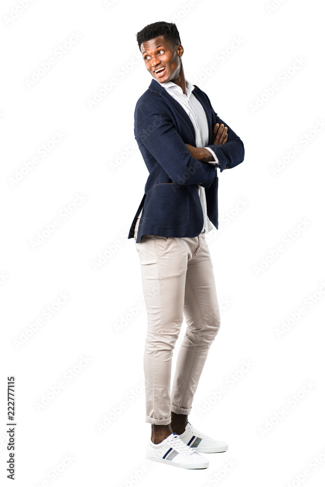 Full body of Handsome african american man wearing a jacket in lateral position while looking over the shoulder with a smile on white background Full body of Handsome african american man wearing a jacket in lateral position while looking over the shoulder with a smile on white background