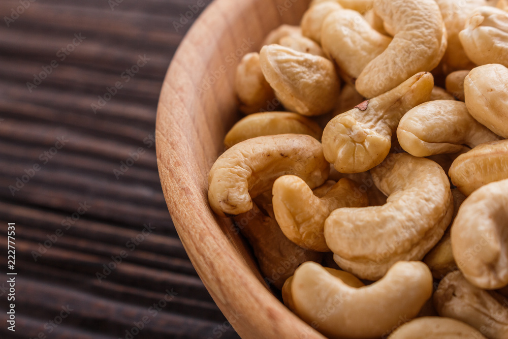Fototapeta premium cashew nuts on a rustic wooden background