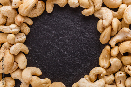 cashew nuts on a dark stone background