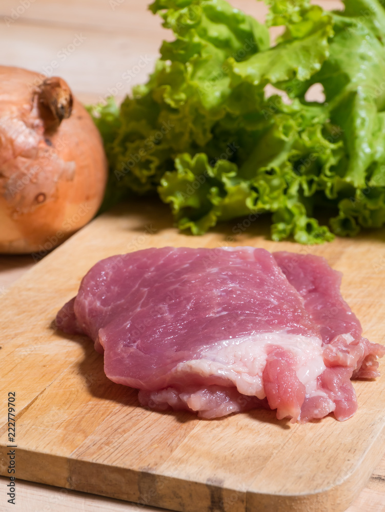 Raw meat in chopping block on onion background, Raw meat in chopping block on onion background,